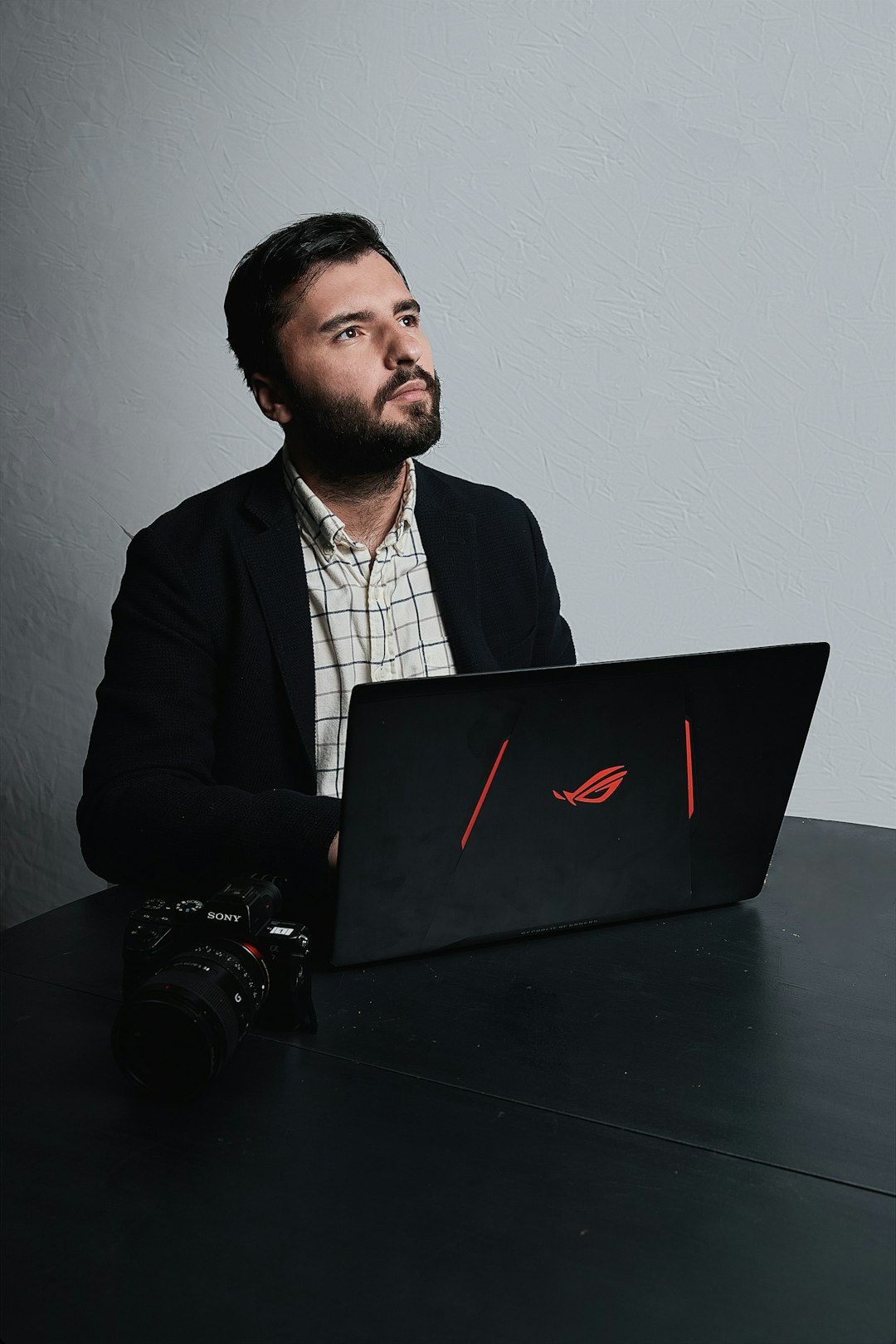 Adrien lopes consultant SEO sur Paris, avec un appareil photo posé sur la table, réfléchi à une stratégie média